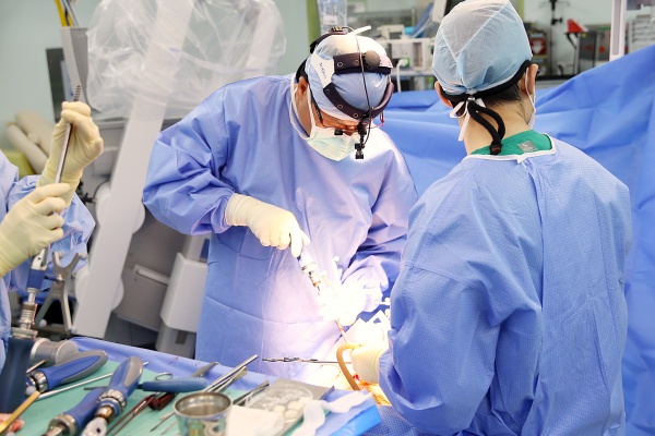 박진훈(사진 왼쪽) 서울아산병원 신경외과 교수가 전이성 척추 종양 환자를 수술하고 있다.